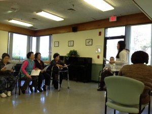Klara Kim interpreting at a meeting of Korean residents of Longwood.